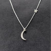 Celestial Star Moon Clavicle Necklace – gold chain with star and moon motifs on a model’s collarbone
