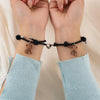 Couple wearing matching bracelets, showcasing unisex design and magnetic hearts