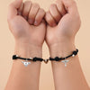 Couple wearing matching bracelets, showcasing unisex design and magnetic hearts