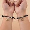 Couple wearing matching bracelets, showcasing unisex design and magnetic hearts