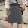 Gray skirt paired with oversized sweater 