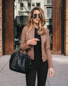 Jacket styled with accessories and handbag