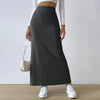  Model styling skirt with boots and handbag 