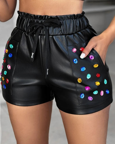 Model wearing PU leather rhinestone shorts
