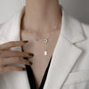 Silver Rectangle Pendant Necklace – minimalist pendant on a delicate chain, styled on a model