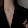Silver Rectangle Pendant Necklace – minimalist pendant on a delicate chain, styled on a model