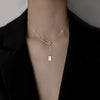 Silver Rectangle Pendant Necklace – minimalist pendant on a delicate chain, styled on a model