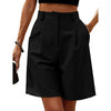 Model walking outdoors in loose-fit black shorts