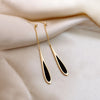 Tassel earrings styled with layered for a bohemian aesthetic