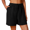 Model wearing black cotton linen shorts outdoors