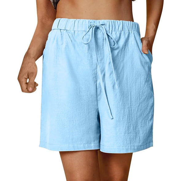 Model wearing blue cotton linen shorts outdoors