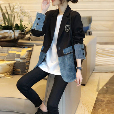 Woman wearing denim patchwork blazer with embroidery