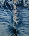 Close-up of distressed denim and stitching 