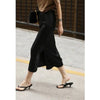 side  view of black satin split midi skirt