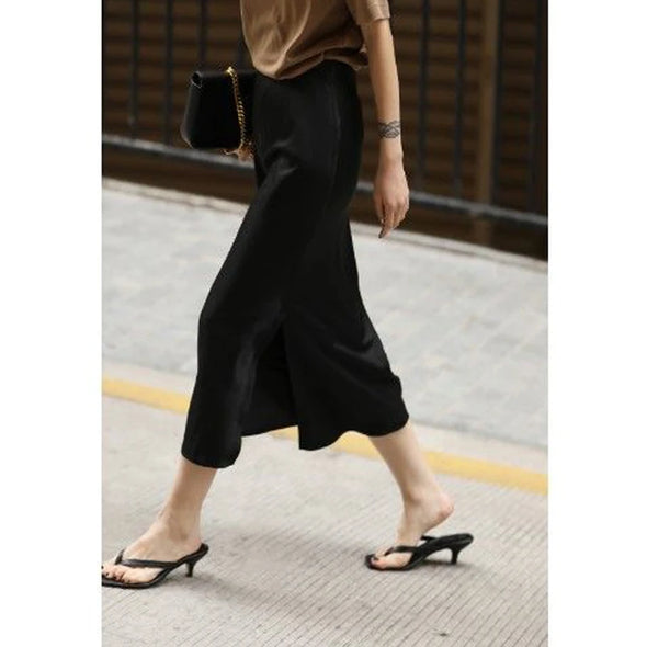 side  view of black satin split midi skirt