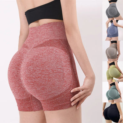 Model wearing high-waist yoga shorts in gym setting